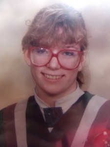 High school graduation photo with giant, red glasses