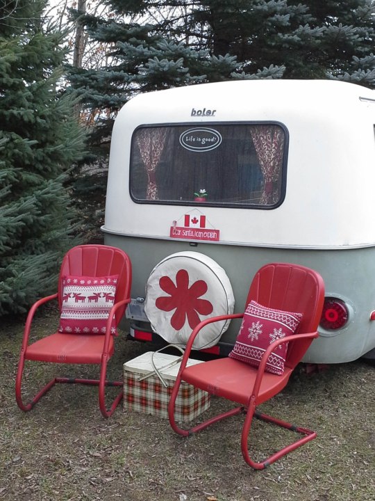 green and white boler decorated with red chairs, ,pillows and a vintage metal cooler
