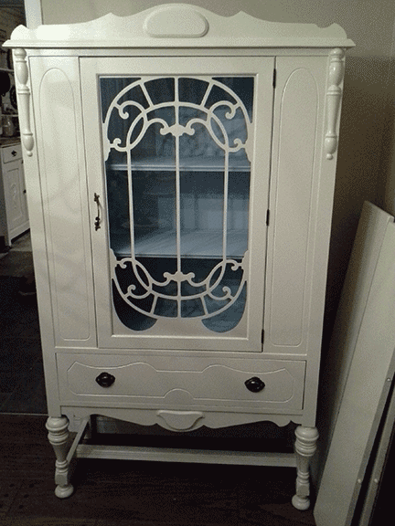 Painted china cabinet shown with door closed