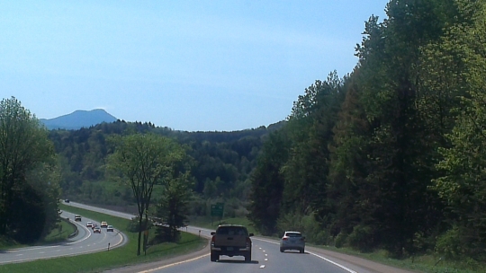 highway view in Vermont - green leaves and mountains