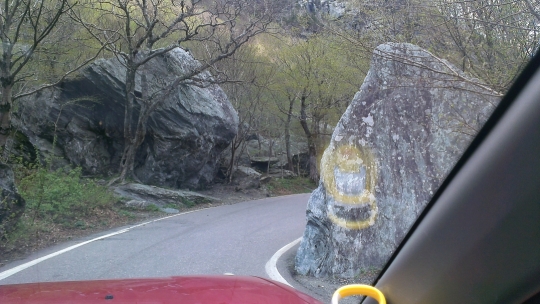 huge boulders alongside hairpin turn of road