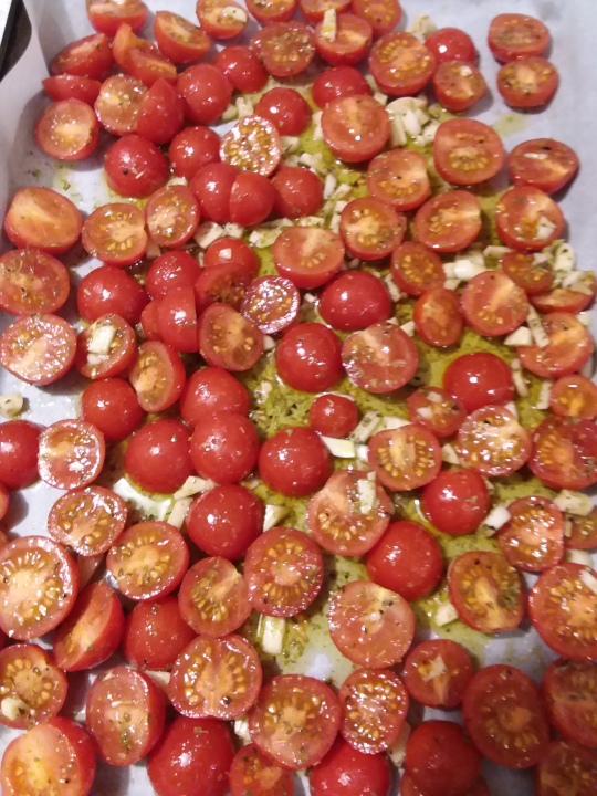 cooke sheet full of roasted red cherry tomatoes